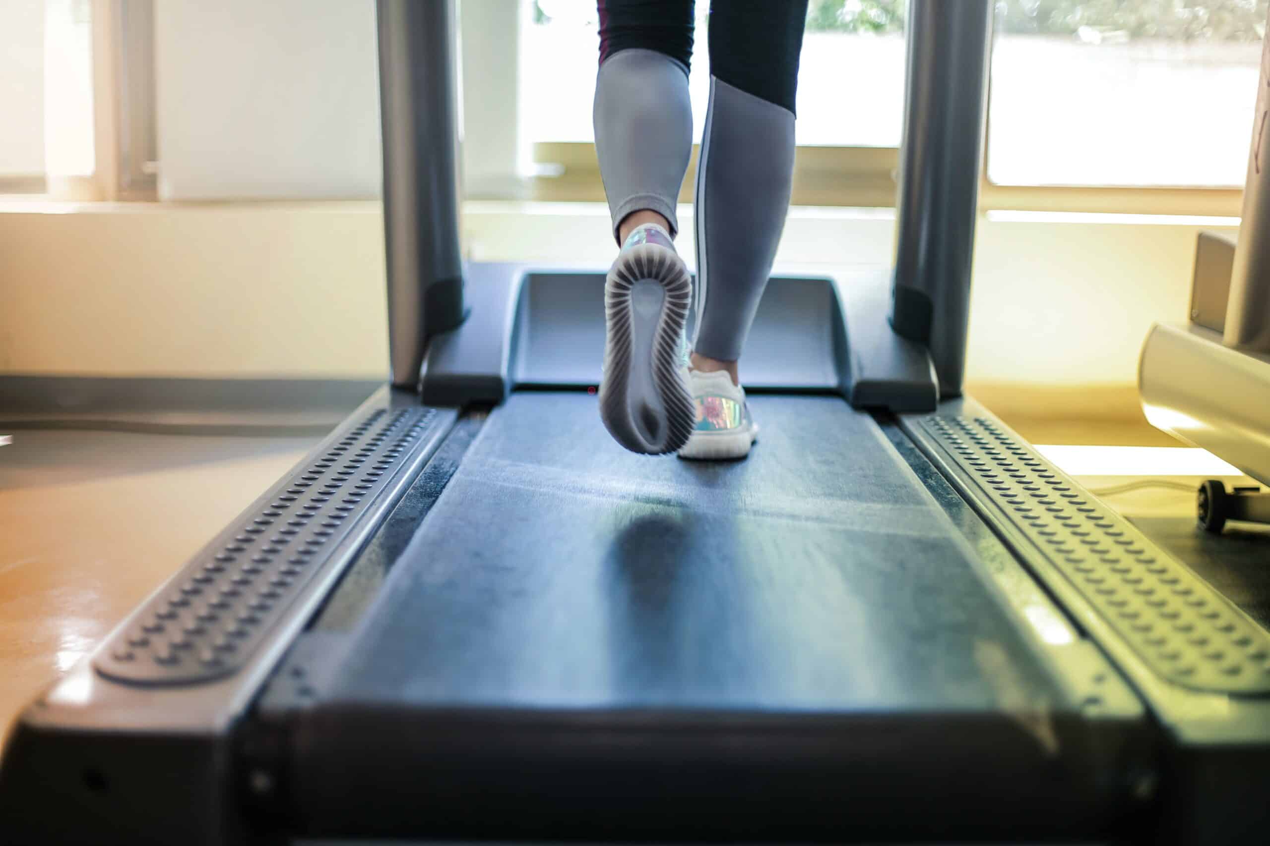 close-up of a woman running on a treadmill