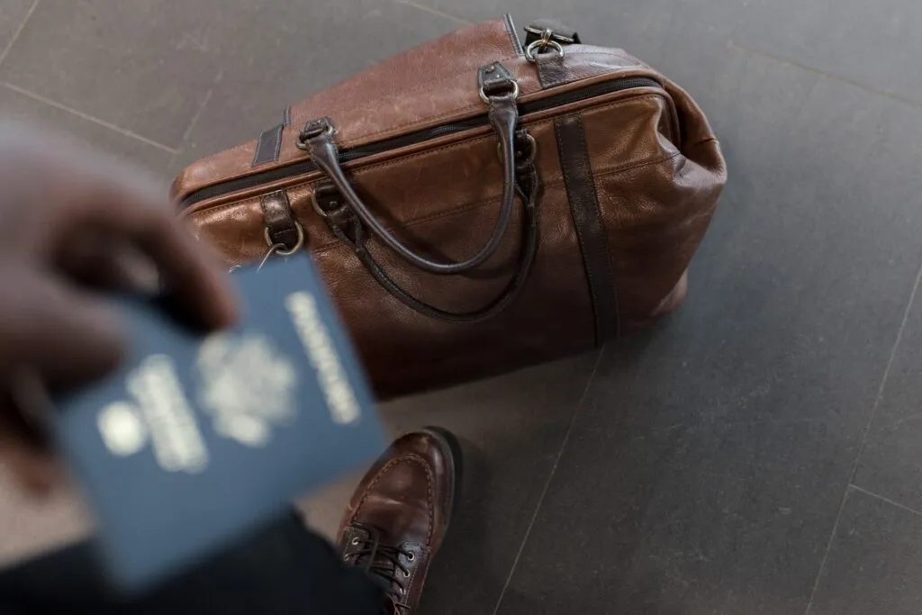 A Close-up shot of a person's passport and travel bag