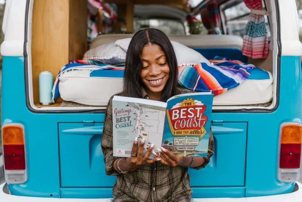 Woman reading tips for designing a home that travels with you across continents in a magazine