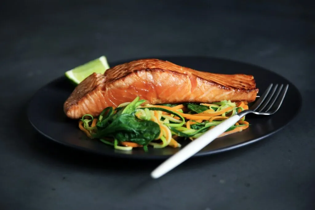 Picture of cooked fish and vegetables on a plate