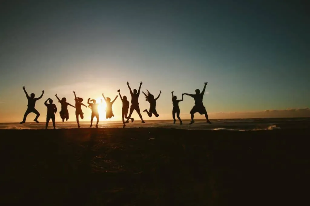 A group of people jumping during golden time.