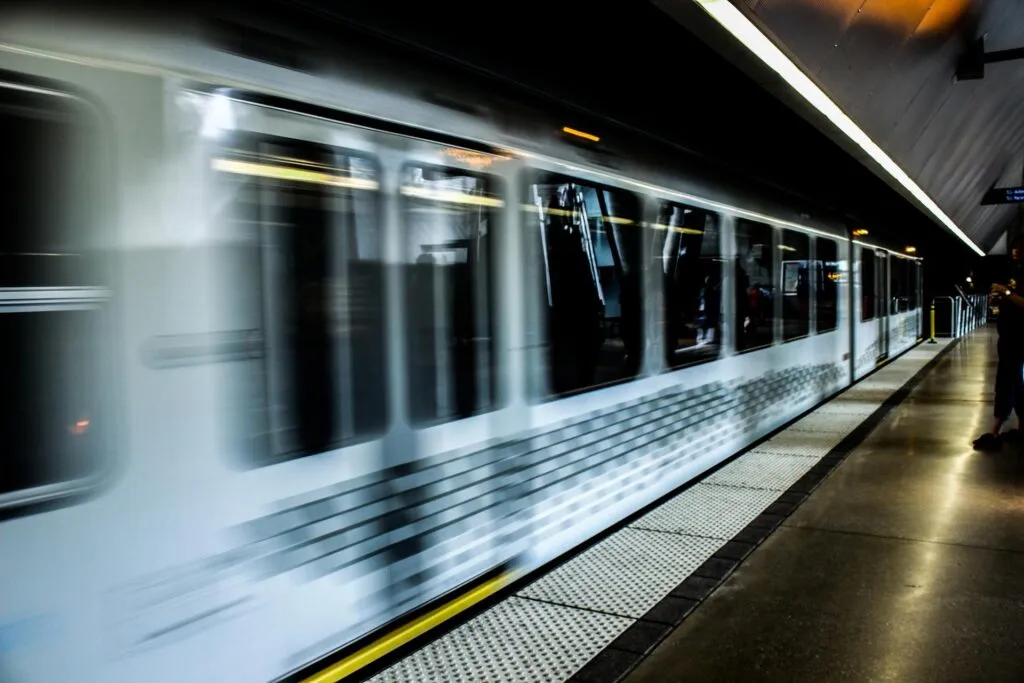 A picture of a metro train that has arrived at its station.