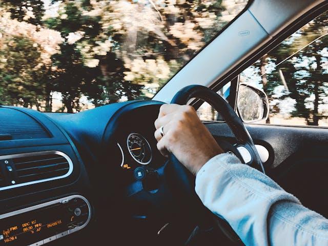 A man holding the steering wheel