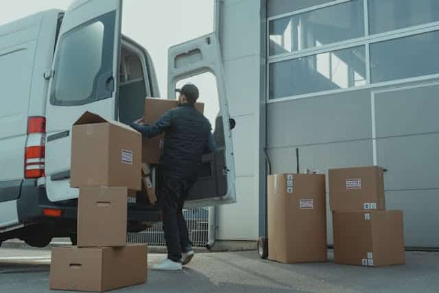 Person loading boxes in a van