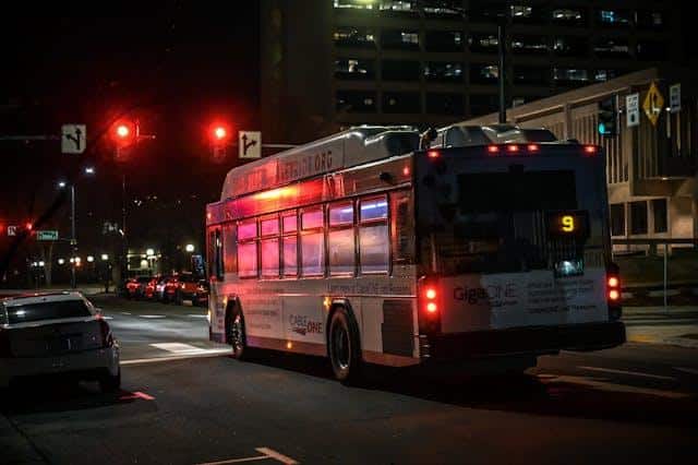A bus on a street at night