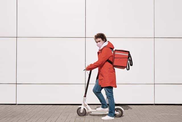 delivery man riding a scooter