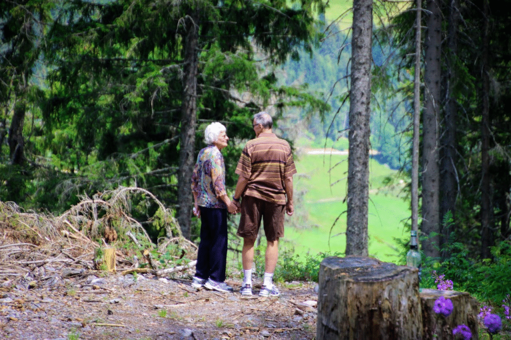 Two people standing in a forest
