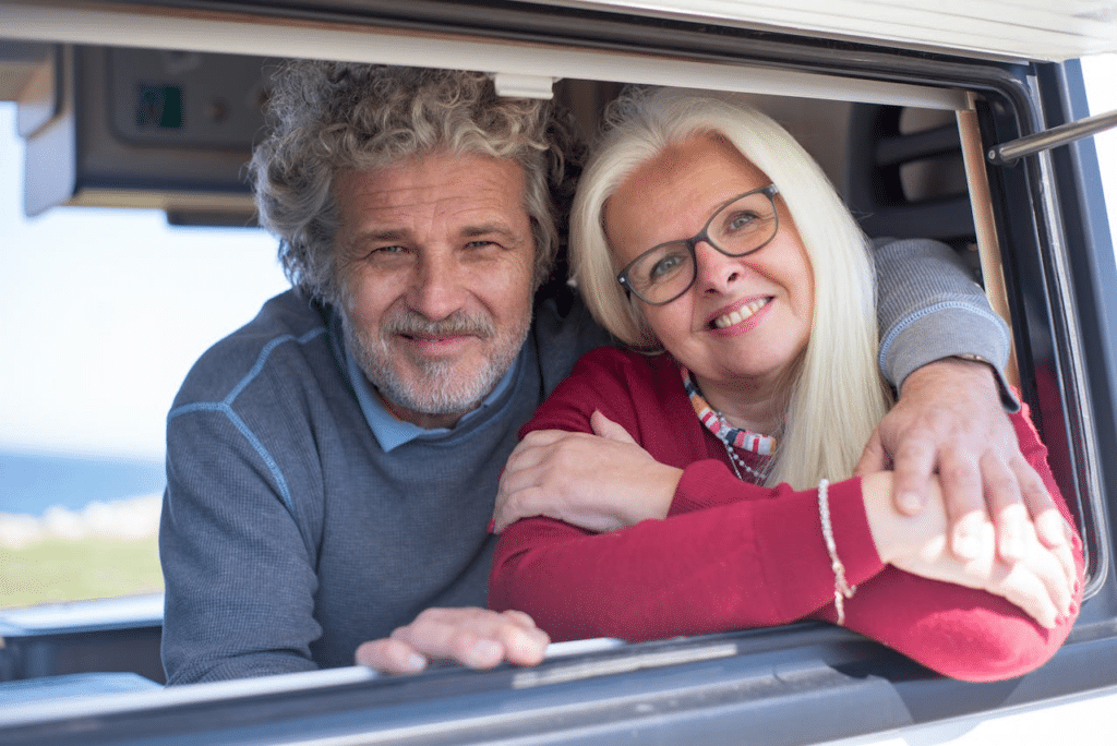 elderly couple sitting in the car